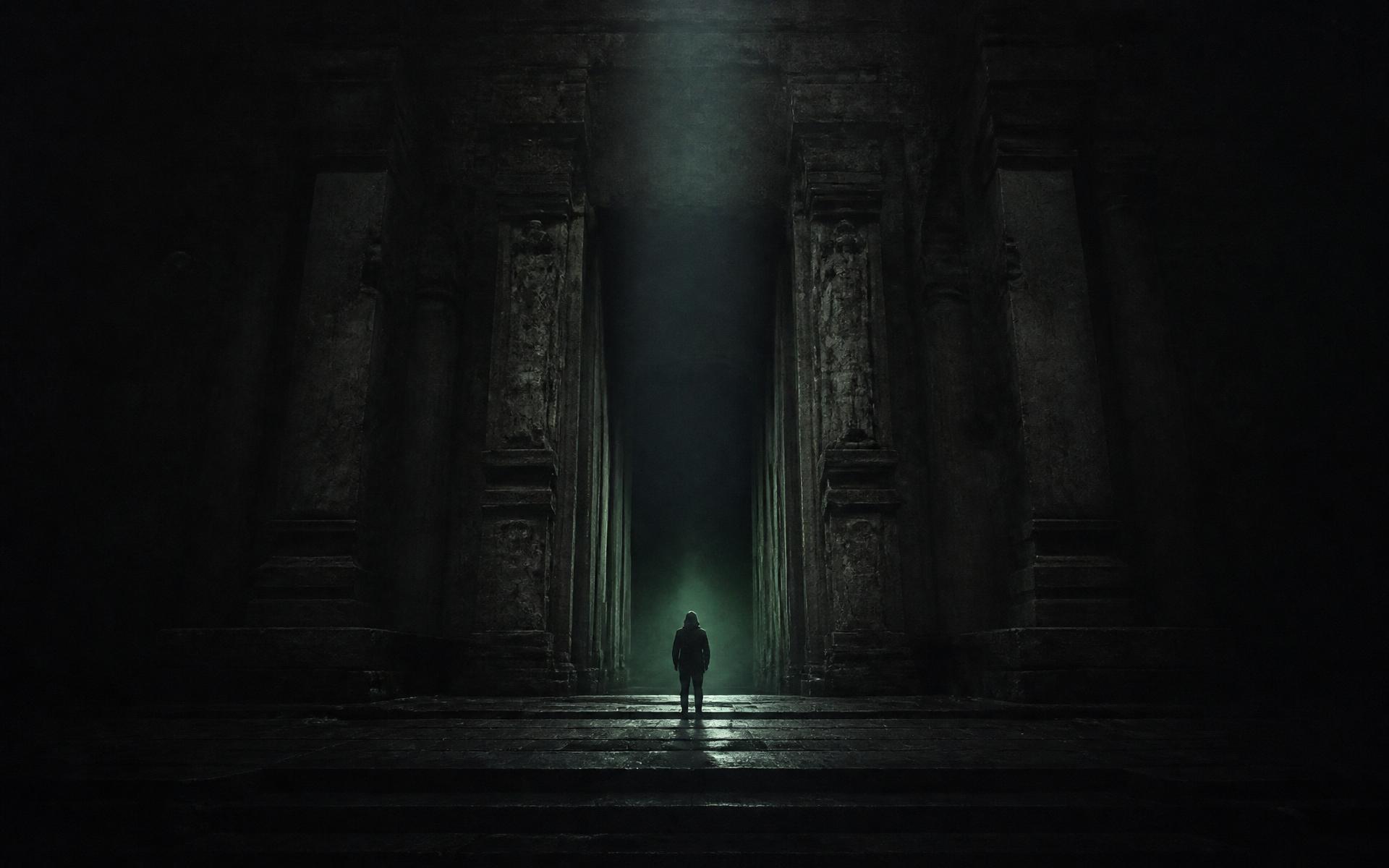A solitary figure standing before a monumental ancient gateway with light beyond